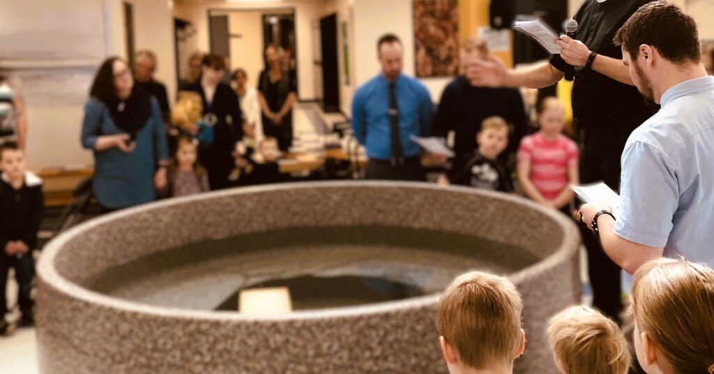 People gathered around baptismal pool