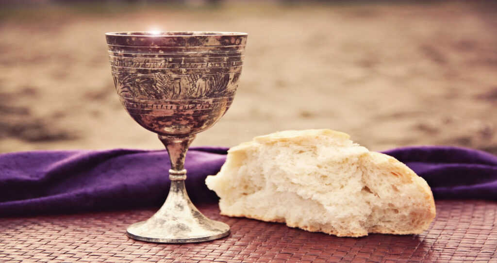 bread and cup of wine on an altar table